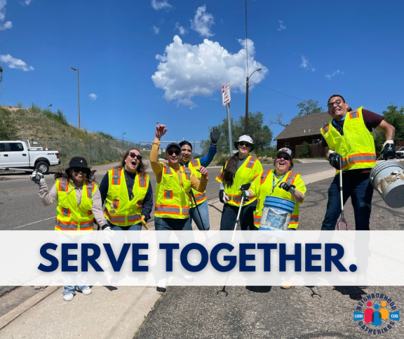 A graphic that reads "Serve Together" overlayed over a photo of people in safety vests participating in a cleanup.
