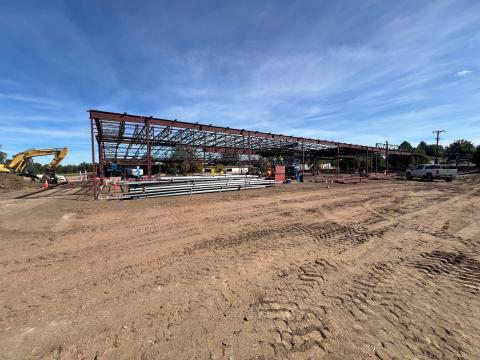 Work on the senior center renovation has progressed to a steel building frame. Construction equipment and workers are on-site.