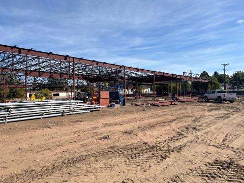 Work on the senior center renovation has progressed to a steel building frame. Construction equipment and workers are on-site.