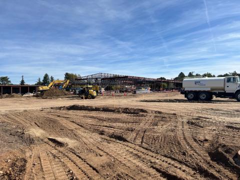Work on the senior center renovation has progressed to a steel building frame. Construction equipment and workers are on-site.
