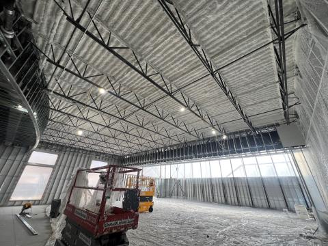 Another view of the interior of the Senior Center in progress, with the steel frame of the ceiling visible.