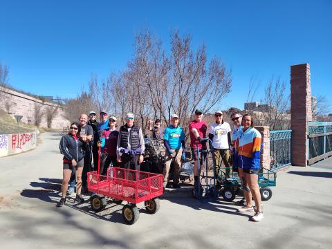 The Pikes Peak Road Runners take a group photo together on a sunny day.