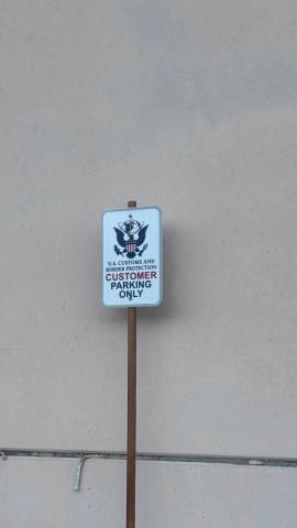 Sign that reads "U.S. Customs and Border Protection Customer Parking Only"