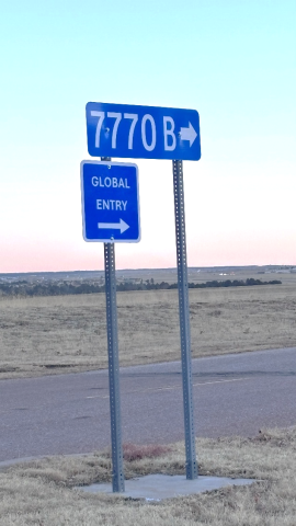 Sign directing drivers to 7770 B Milton E. Parkway, the address of the Global Entry Center