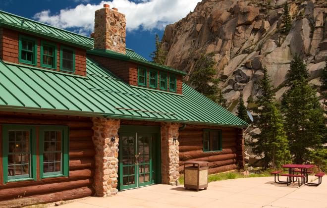a red picnic table on the patio outside the Glen Cove gift shop log cabin