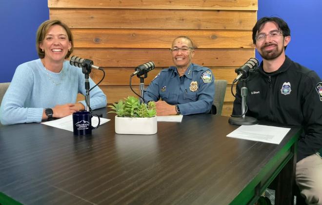 From left to right: Jen Schreuder at the Behind the Springs desk with Deputy Chief Mary Rosenoff Officer Daniel Short.