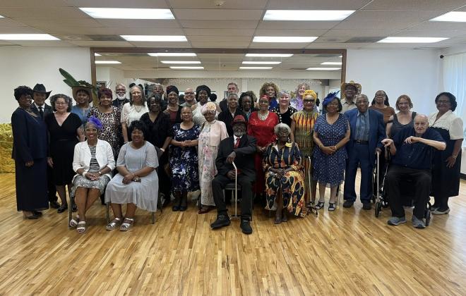 A group of seniors attend the Senior Prom and take a group photo together at Hillside Community Center
