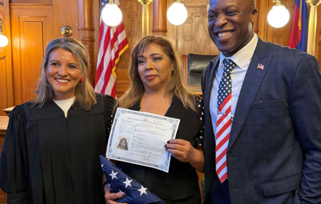 Mayor Yemi takes a photo with a newly naturalized citizen and the judge who presided over the naturalization ceremony.