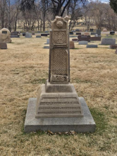 Broken sandstone Celtic cross headstone above the grave of James Clark's son.