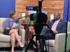 Jen Schreuder laughs in the Behind the Springs studio with Mayor Yemi